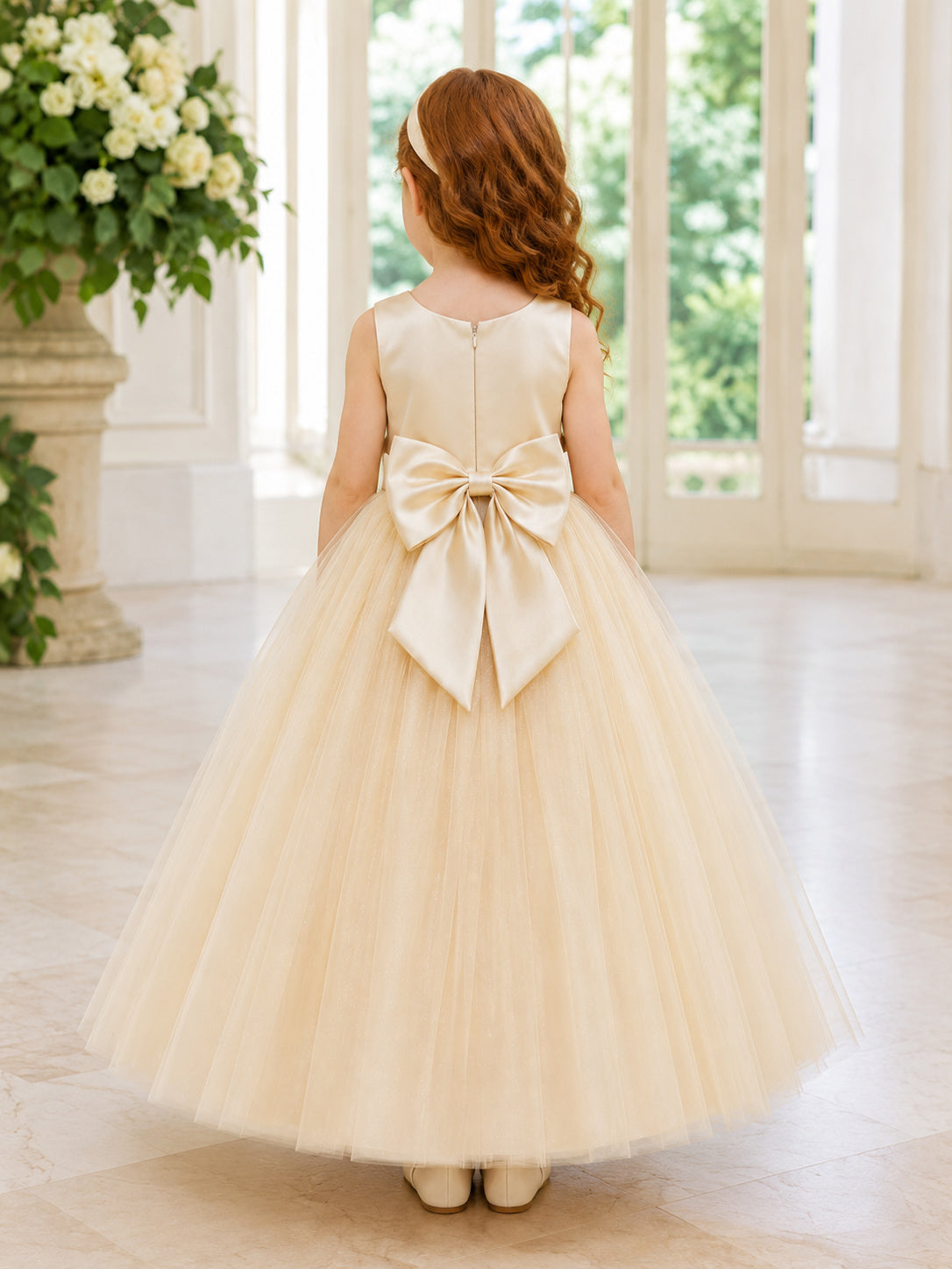 Champagne Tulle A-Line Flower Girl Dress with Sleeveless, jewel Neckline, and Tea length Skirt with Bow Accents back view