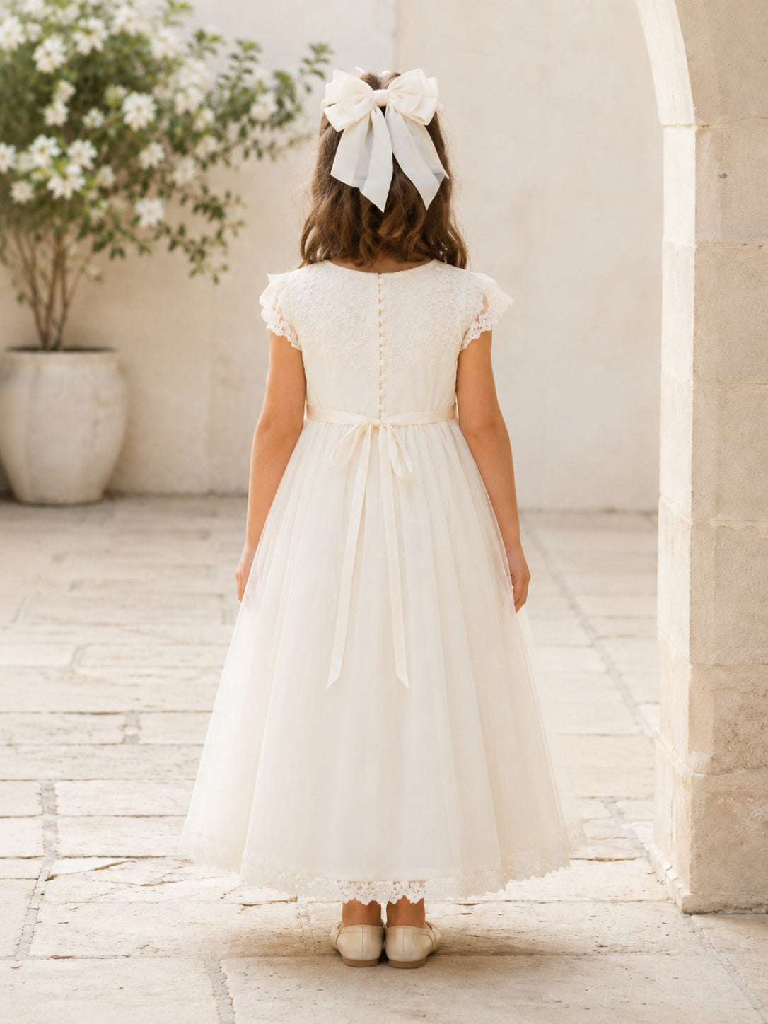 White Tulle A-Line Flower Girl Dress with Cap Short Sleeve, jewel Neckline, and Tea length Skirt with Soft Pleating back view