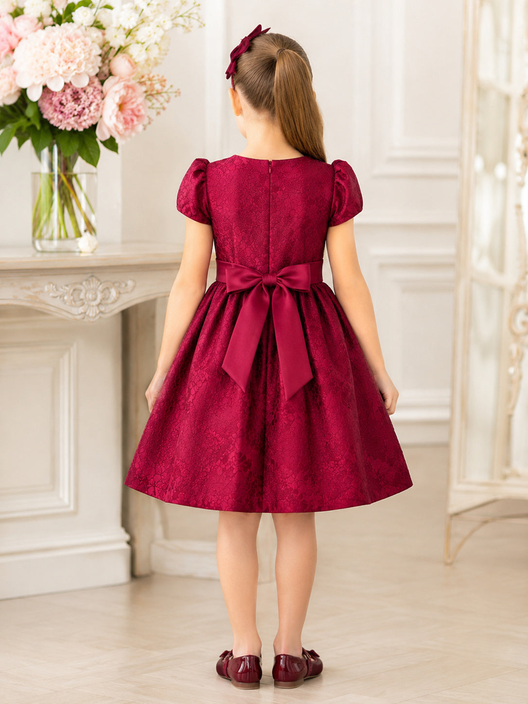 Burgundy Satin A-Line Flower Girl Dress with Cap Short Sleeve, jewel Neckline, and Knee length Skirt with Bow Accents back vi