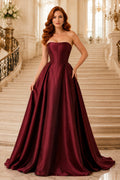 Burgundy strapless satin ball gown with structured bodice and full skirt Floor-length And Sweep/Brush Train Ball Gown Prom Dr
