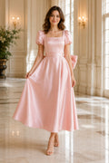 Blushing Pink Puff Sleeve Satin Tea-Length Dress with Square Neck and Bow Back front view