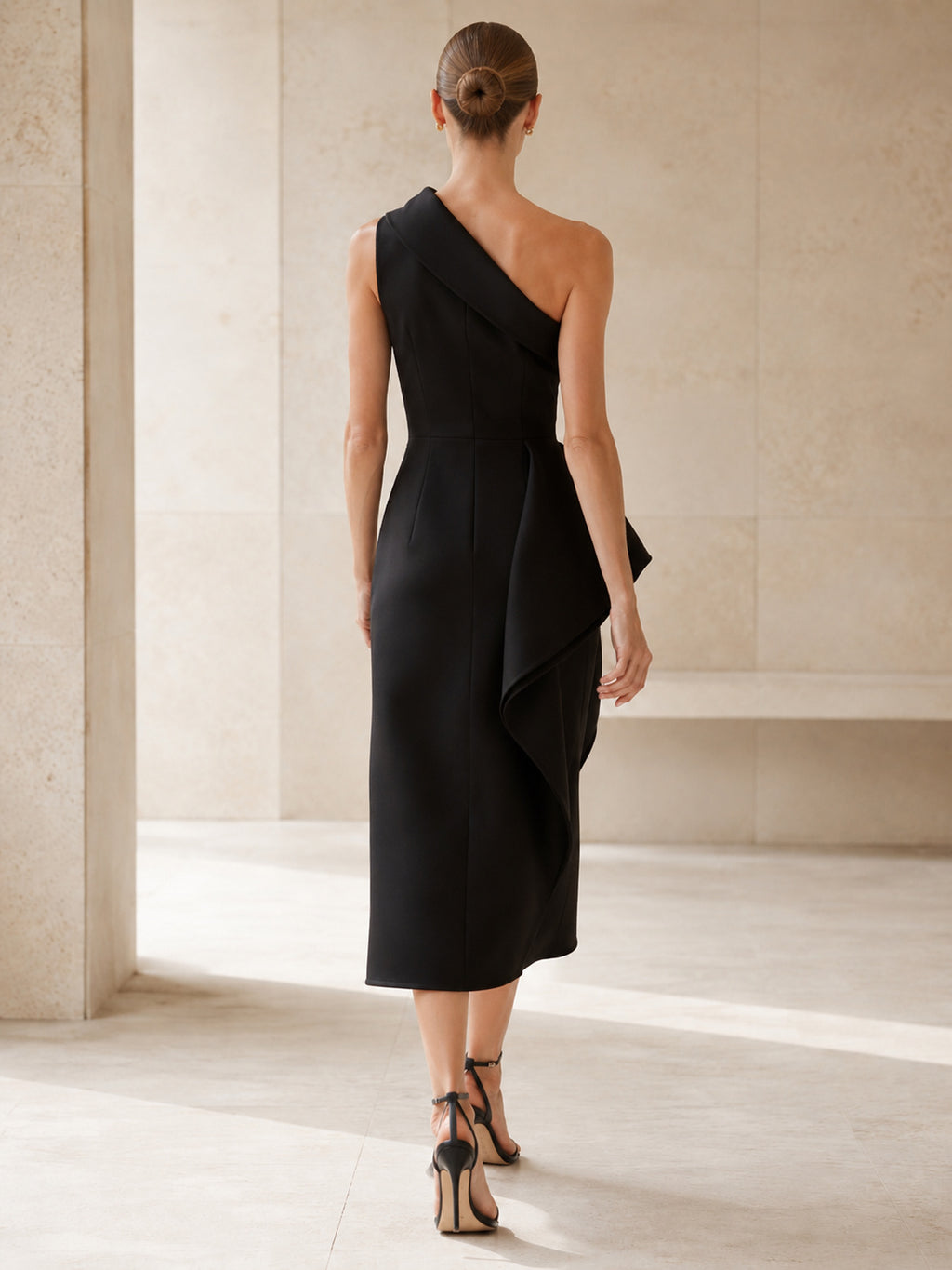 Black one shoulder architectural peplum midi cocktail dress back view
