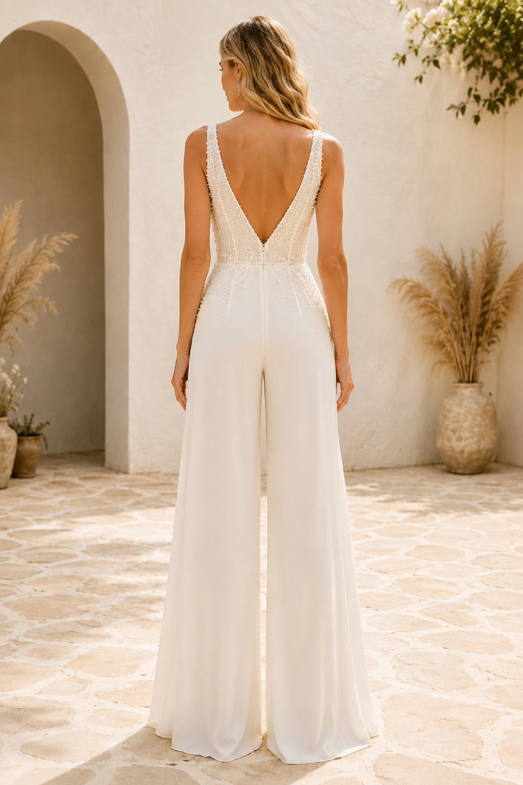 Ivory V-Neck Sleeveless Lace Satin Floor-Length Bridal Jumpsuit with Deep V Bodice and Flowing Wide Leg Pants back view