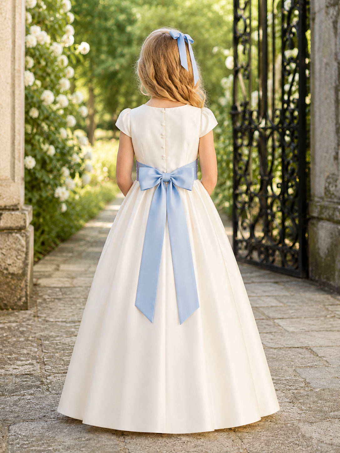 Ivory Satin A-Line Flower Girl Dress with Cap Short Sleeve, jewel Neckline, and Tea length Skirt with Bow Accents back view